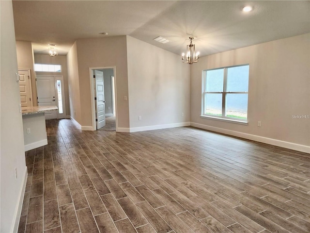 unfurnished room with dark hardwood / wood-style flooring and a chandelier