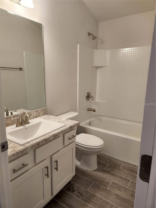 full bathroom with tiled shower / bath combo, vanity, and toilet