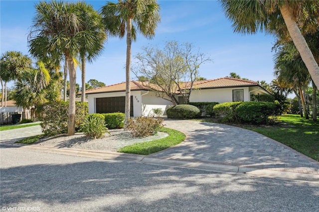 mediterranean / spanish home featuring a garage