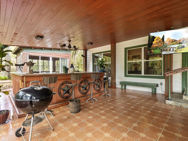 view of patio with area for grilling and outdoor wet bar