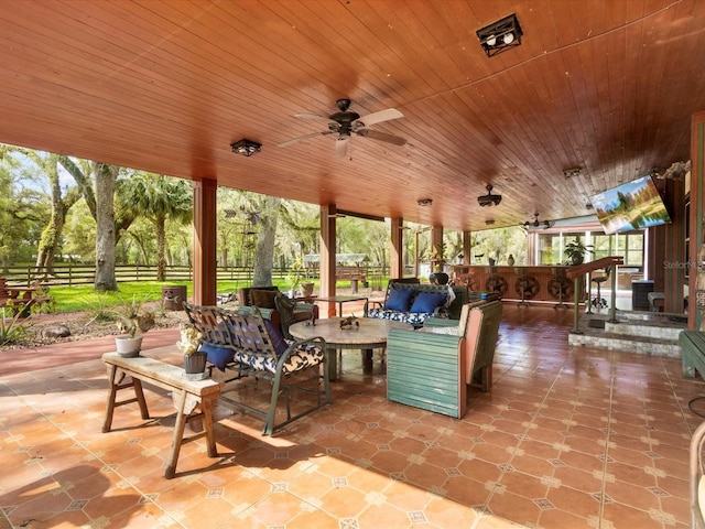 view of patio / terrace with ceiling fan, fence, and an outdoor living space