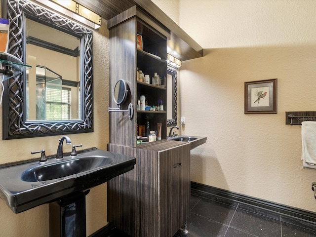 bathroom with lofted ceiling, tile patterned flooring, and sink