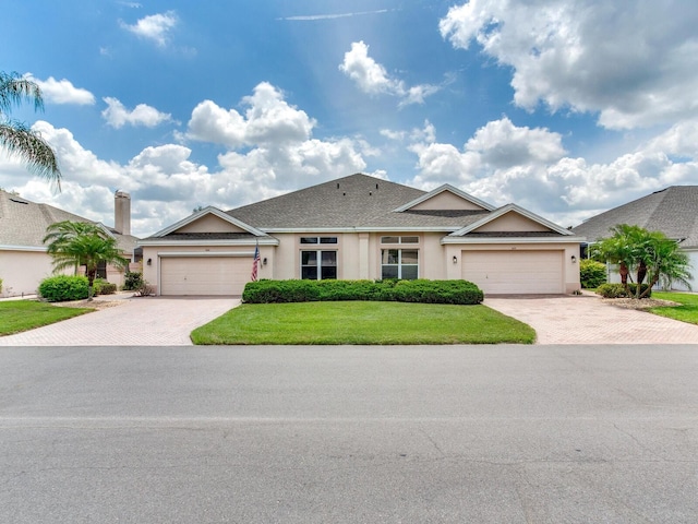 view of front of house with a front lawn and a garage