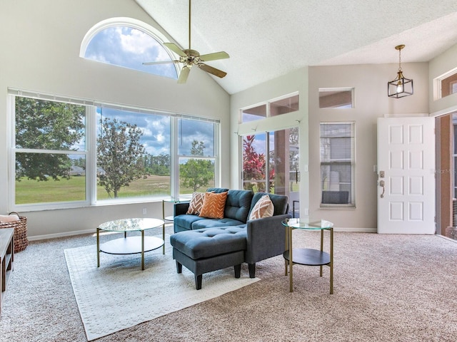 living room featuring light carpet, high vaulted ceiling, ceiling fan, and a textured ceiling