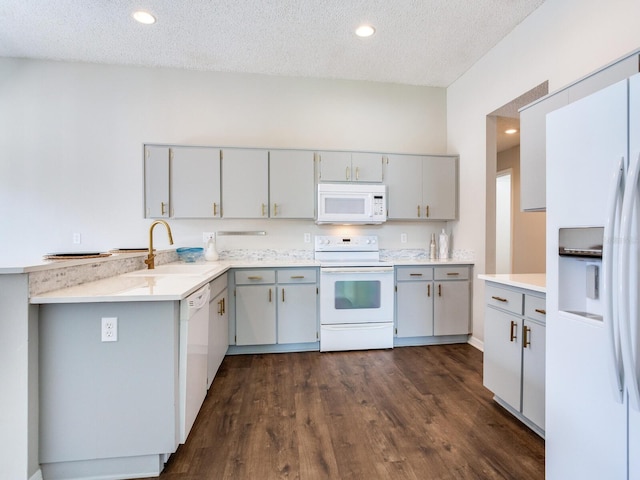 kitchen featuring white appliances, dark wood-type flooring, and gray cabinets