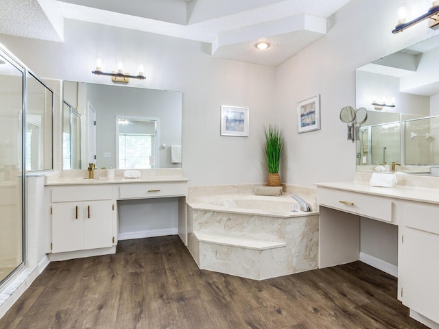 bathroom featuring oversized vanity, shower with separate bathtub, and hardwood / wood-style flooring