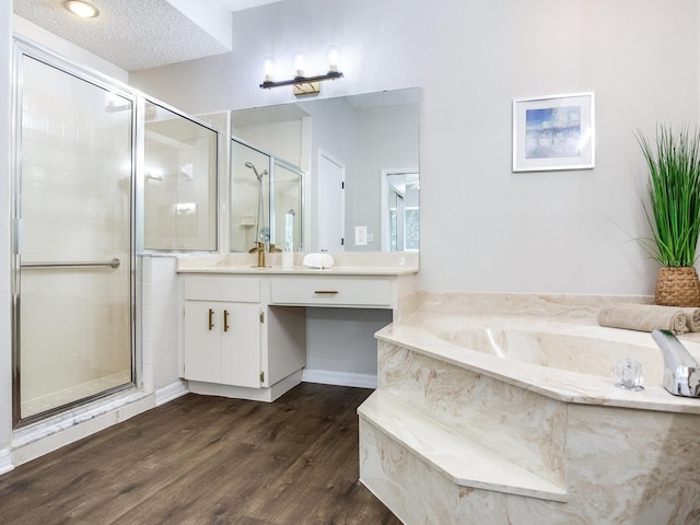 bathroom featuring hardwood / wood-style floors, a textured ceiling, vanity, and independent shower and bath