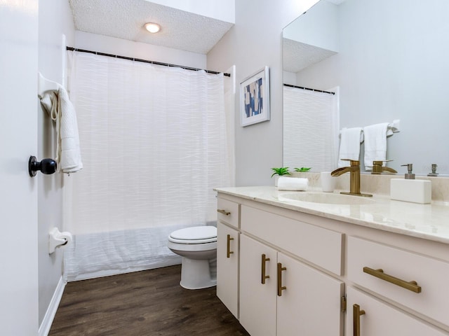 full bathroom with toilet, shower / bathtub combination with curtain, a textured ceiling, vanity, and hardwood / wood-style floors