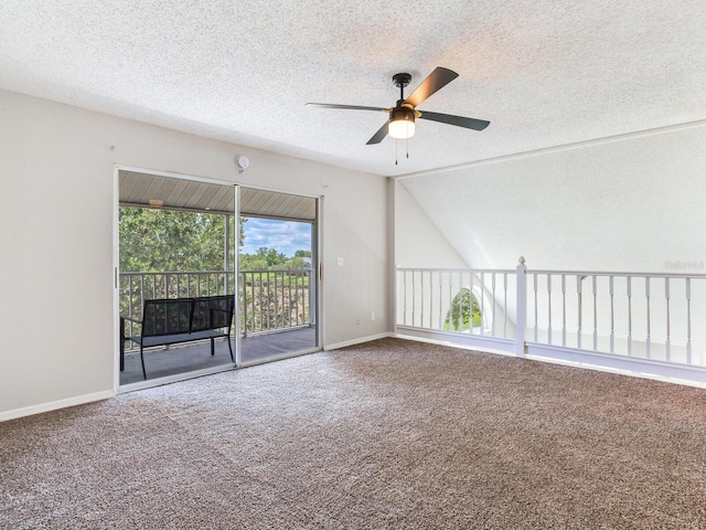 unfurnished room with carpet flooring, a textured ceiling, ceiling fan, and vaulted ceiling