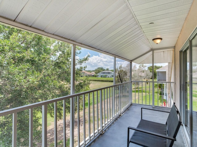 unfurnished sunroom featuring lofted ceiling