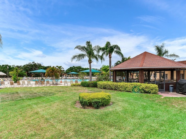 view of yard with a gazebo, a patio area, and a community pool