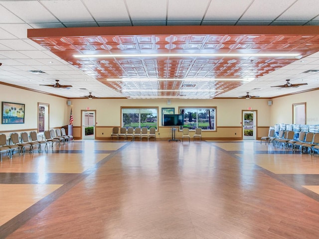 gym with light hardwood / wood-style floors, ceiling fan, and crown molding