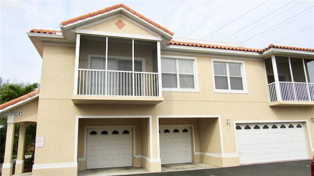 view of property featuring a balcony and a garage