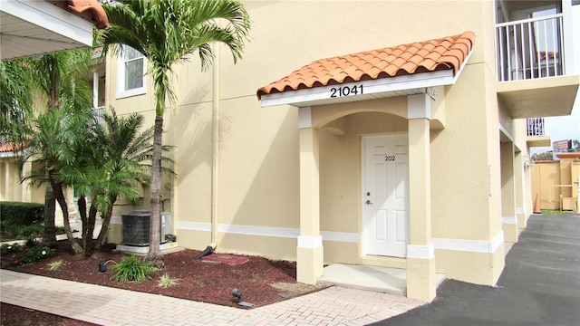 property entrance featuring central AC unit