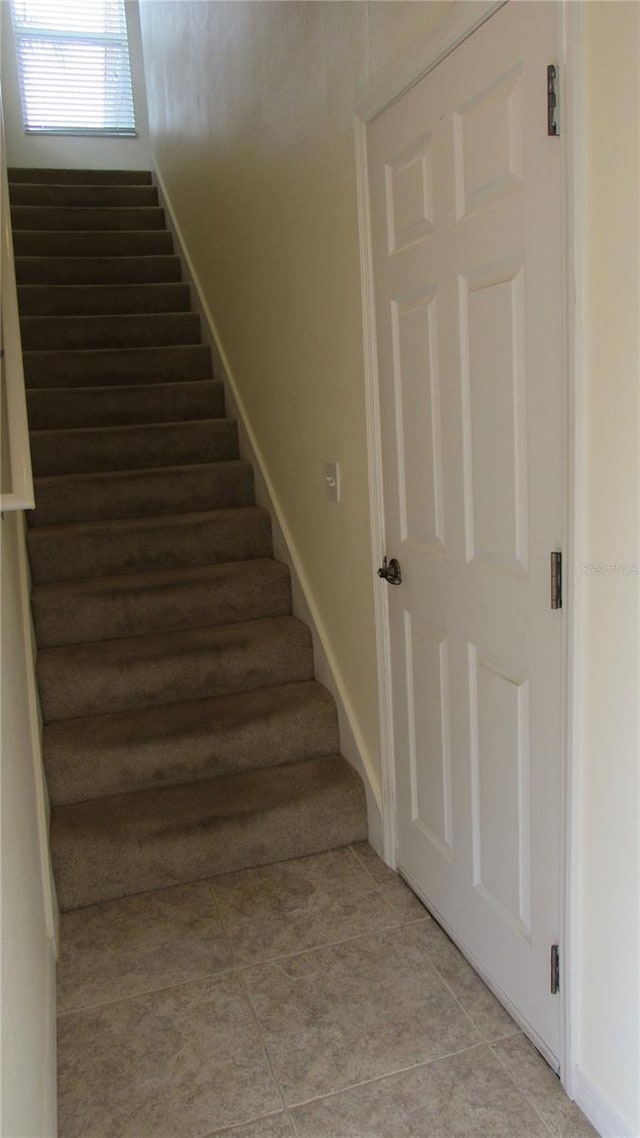 stairs featuring light tile flooring