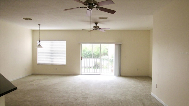 spare room with ceiling fan and light carpet