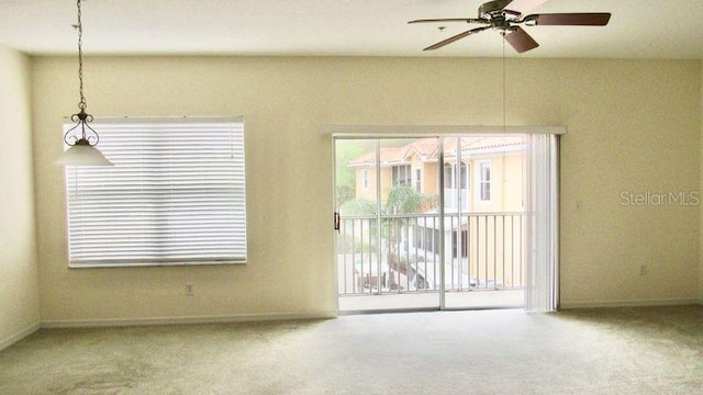 carpeted empty room featuring ceiling fan