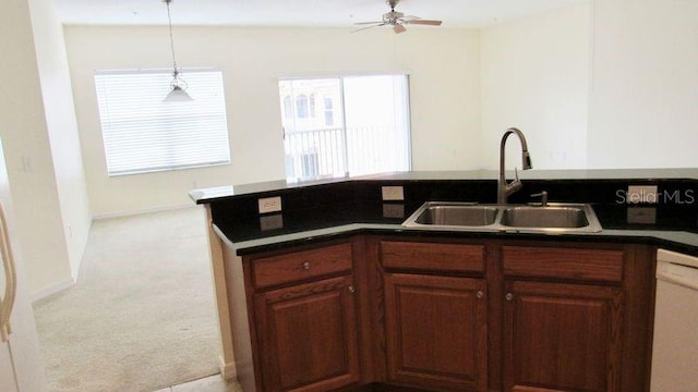 kitchen with light carpet, pendant lighting, ceiling fan, sink, and white dishwasher