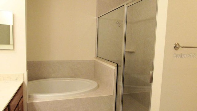 bathroom with plus walk in shower and vanity