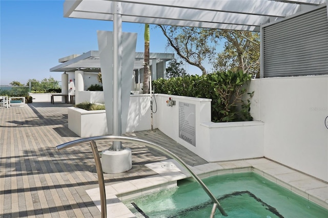 view of pool with an in ground hot tub and a pergola