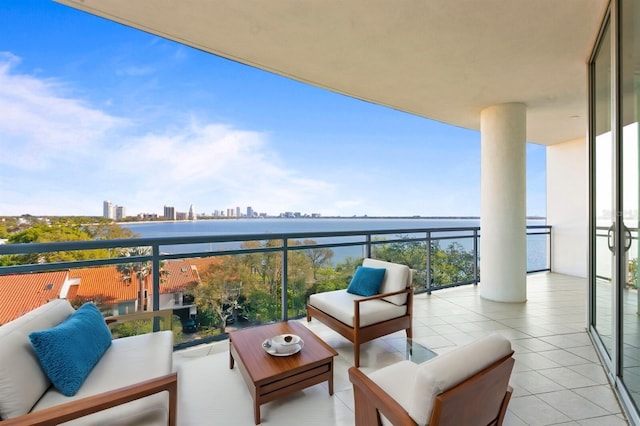 balcony with a water view and an outdoor hangout area