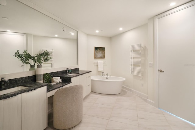 bathroom featuring dual vanity, a bathtub, tile patterned flooring, and radiator heating unit