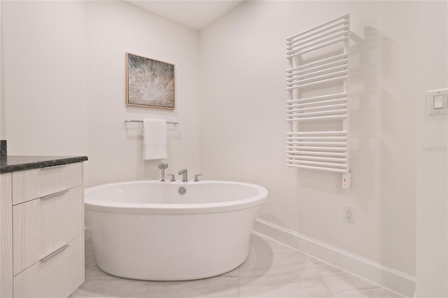 bathroom with a tub to relax in, tile patterned flooring, and radiator