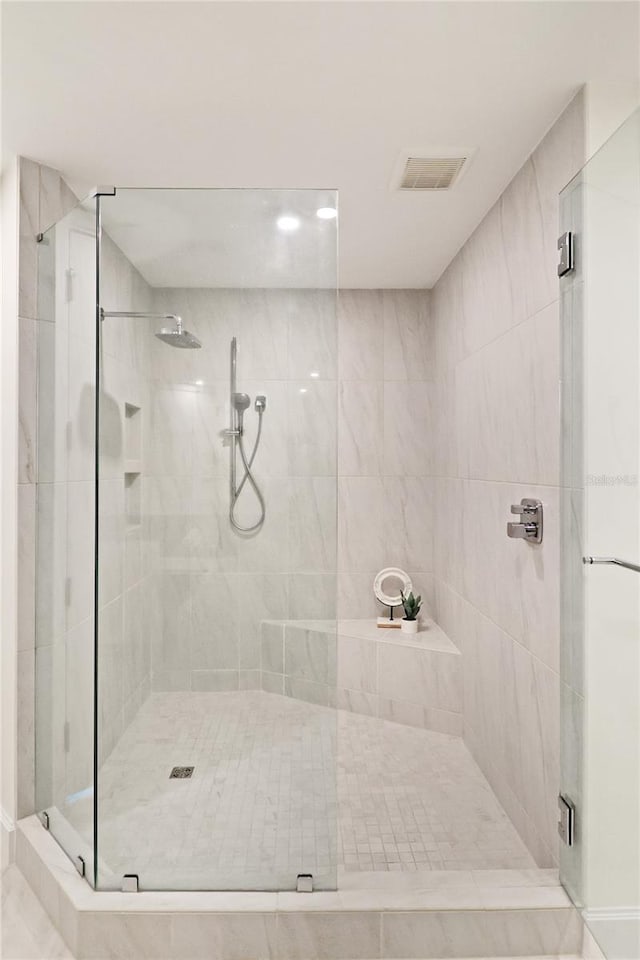 bathroom with a shower with shower door