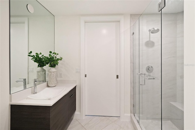 bathroom featuring tile patterned floors, vanity, and a shower with shower door