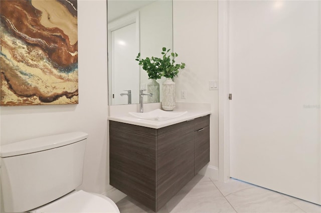 bathroom featuring toilet, vanity, and tile patterned floors