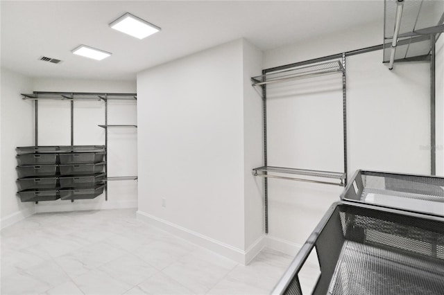 walk in closet featuring light tile patterned flooring