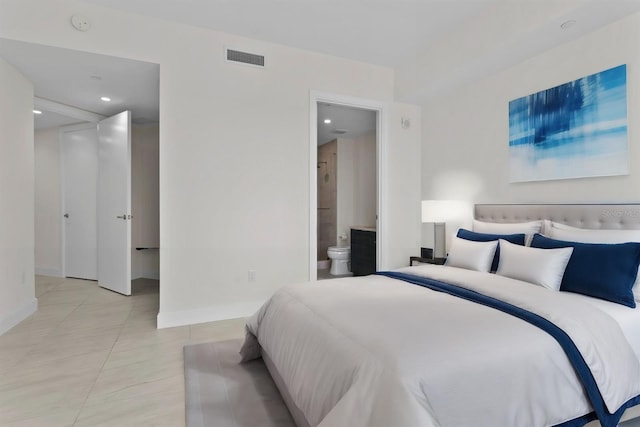 bedroom featuring ensuite bathroom and light tile patterned floors