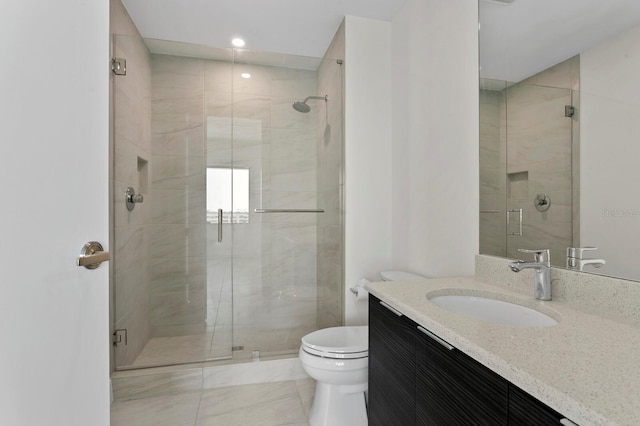 bathroom featuring toilet, vanity, walk in shower, and tile patterned floors