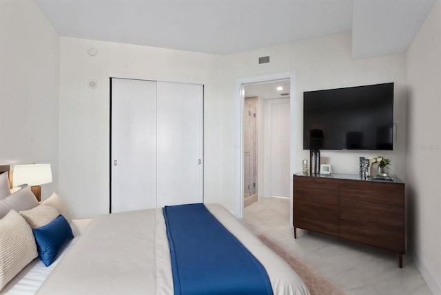 bedroom featuring a closet and light tile patterned floors