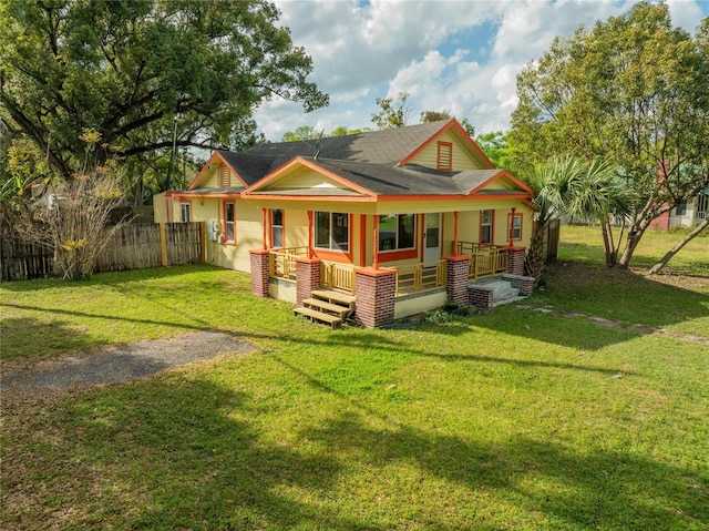 rear view of property with a yard