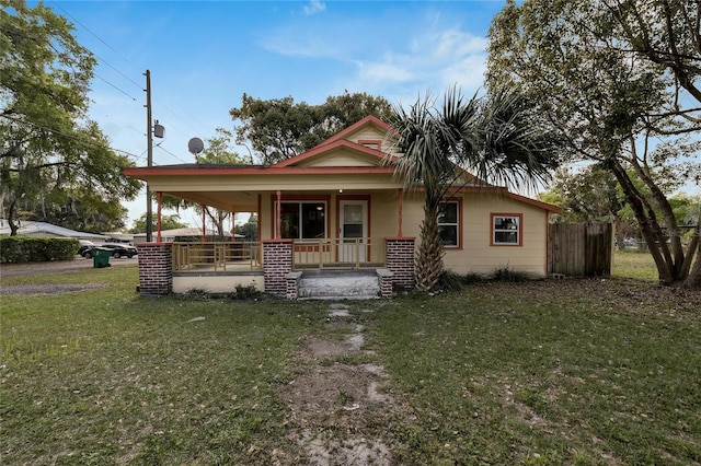 view of front facade with covered porch and a front lawn