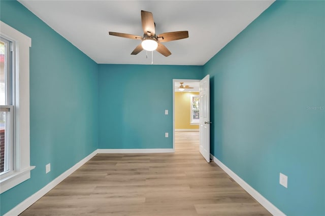 unfurnished room with ceiling fan and light hardwood / wood-style flooring