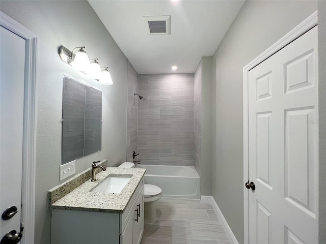 full bathroom with toilet, tile flooring, tiled shower / bath combo, and vanity