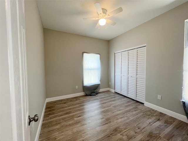 unfurnished bedroom featuring a closet, ceiling fan, and light wood-type flooring