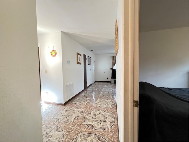 hall featuring light tile floors