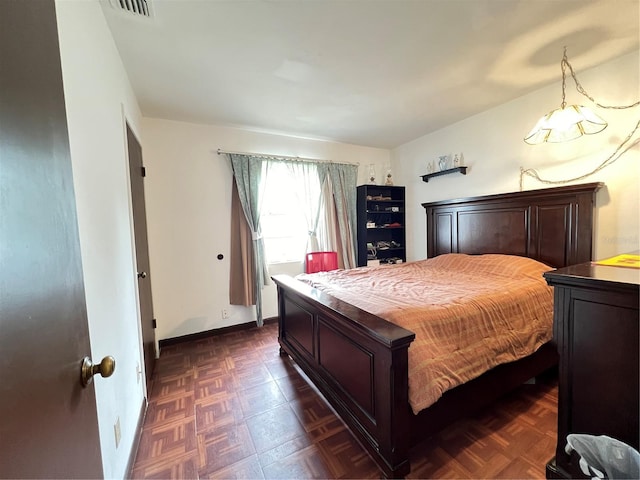 bedroom featuring dark parquet flooring