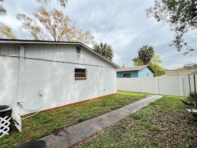 view of side of home with a lawn