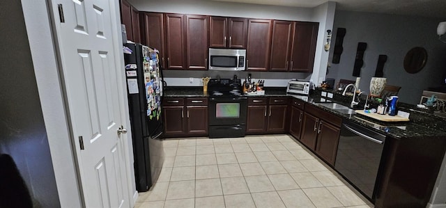 kitchen with dark stone countertops, sink, black appliances, and light tile flooring