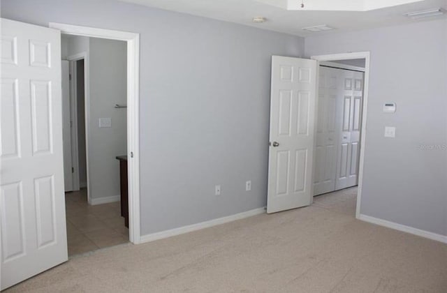 unfurnished bedroom with light colored carpet