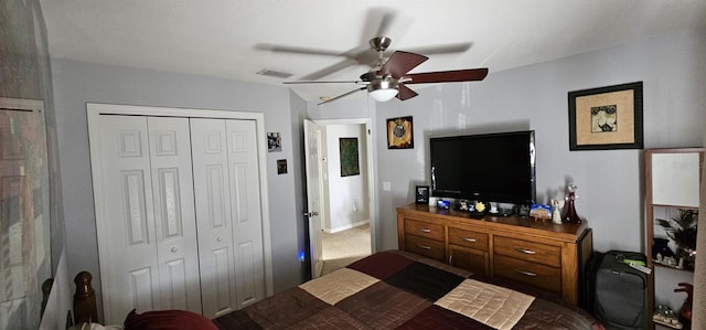 carpeted bedroom featuring ceiling fan and a closet