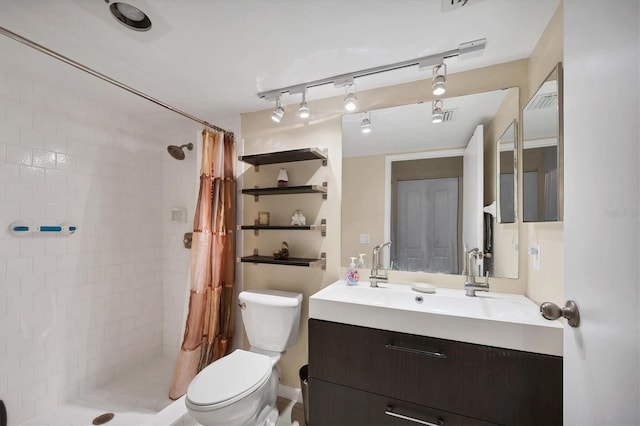 bathroom featuring vanity, toilet, and curtained shower