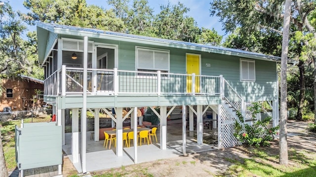14640 W Black Creek Dr, Crystal River, FL 34429 - back of property with a patio area, metal roof, and stairs