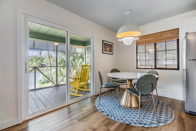 dining space featuring dark wood-type flooring