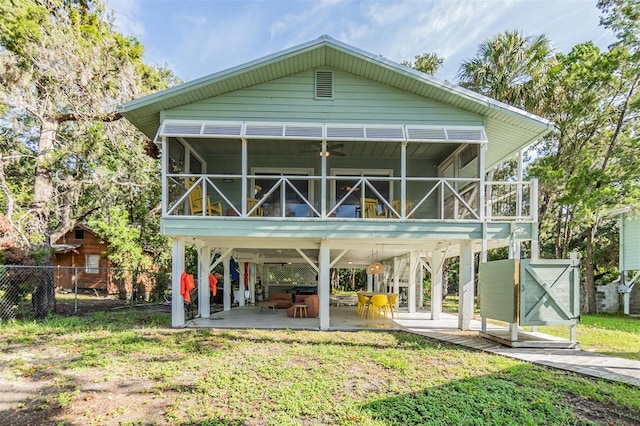 view of front of house with a patio, a front lawn, a sunroom, and ceiling fan