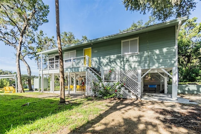 14640 W Black Creek Dr, Crystal River, FL 34429 - rear view of house featuring stairs and a carport